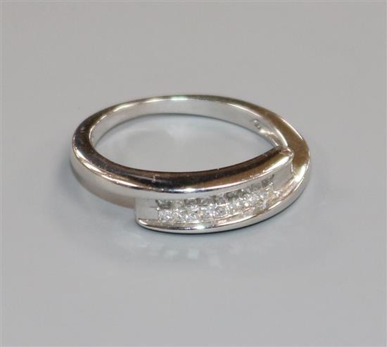 A white metal and eighteen stone diamond twin row dress ring, size J.